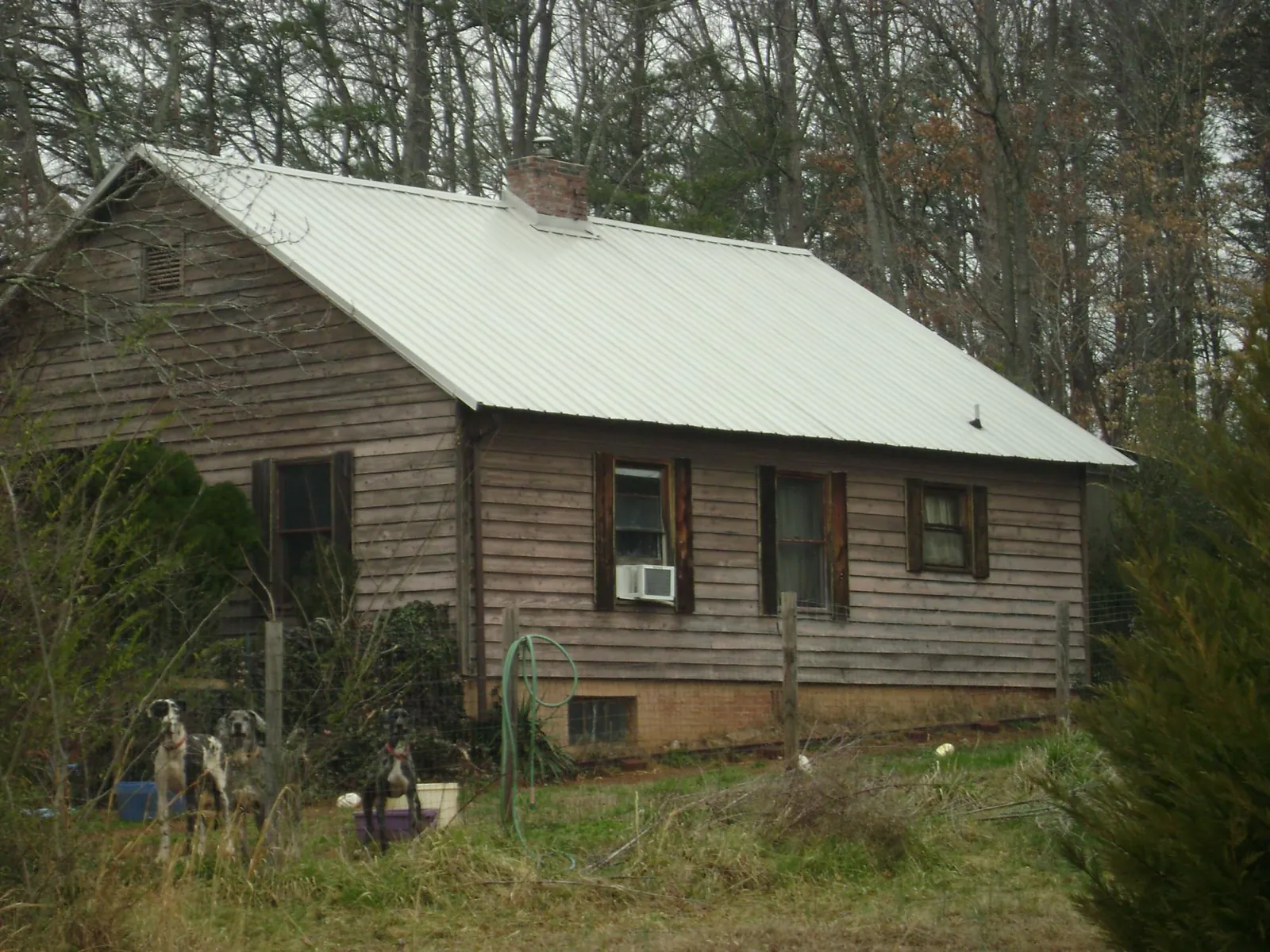 White metal roof on an old wood sided farmhouse, from a Metal Roof Installation job in Leasburg